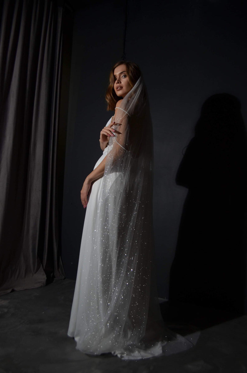 http://www.oliviabottega.com/cdn/shop/products/Glittering-White-Wedding-Veil-2-by-Olivia-Bottega---Wedding-Veil---Bridal-Veil---Sparkling-Veil---White-Wedding-Veil---Choice-of-Length-OLIVIABOTTEGA-1617995410_5a4f5836-5744-414d-91fd-3c5041e86aa0_1200x1200.jpg?v=1700401228