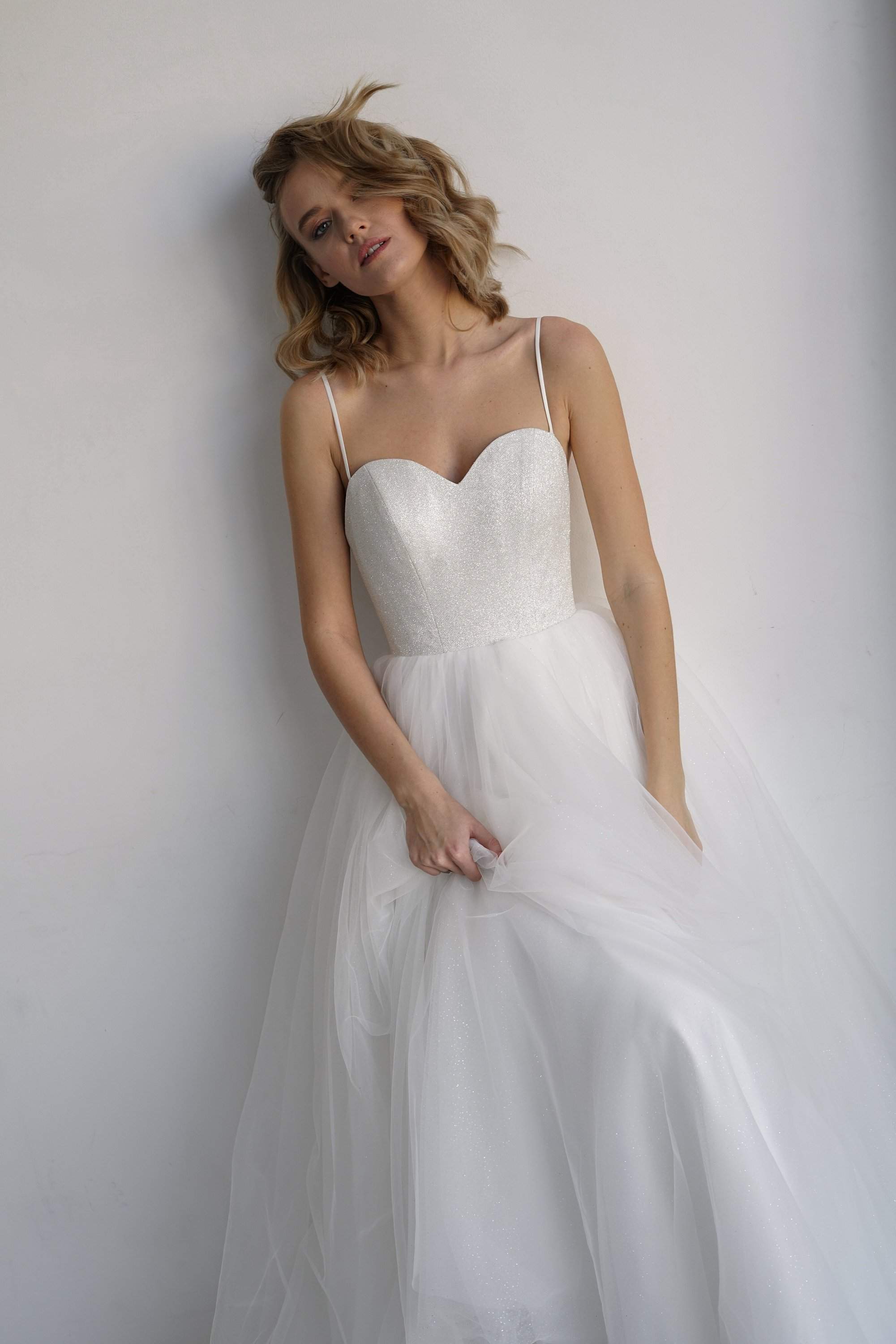 https://www.oliviabottega.com/cdn/shop/products/Wedding-dress-KLOUZI-by-Olivia-Bottega-with-glistening-long-and-midi-skirt.-Open-Ball-delicate-wedding-dress-without-sleeves.-oliviabottega-1609193076.jpg?v=1630019607